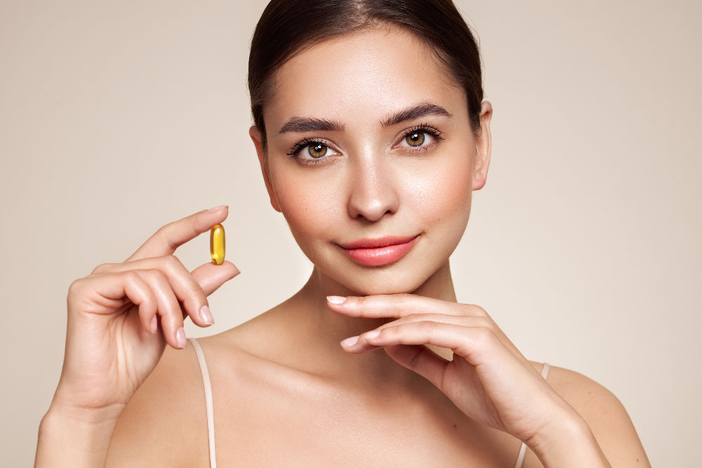 Vitamins. Close Up Of Happy Beautiful Girl With Pill With Cod Liver Oil Omega-3