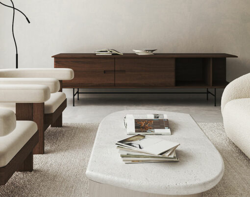 White living room interior with sofa and armchairs, coffee table with books and decoration dark wooden commode