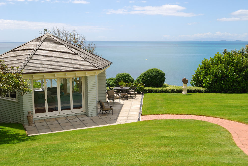 curve way leads to elegant gazebo with sea and blue sky background