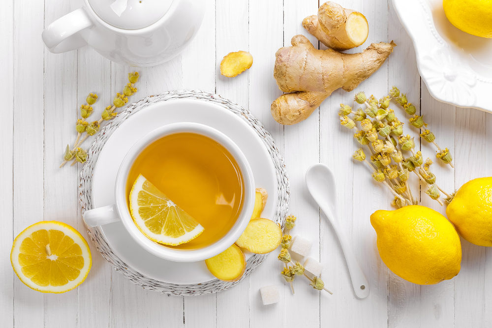 tea cup with lemon, ginger and herbs