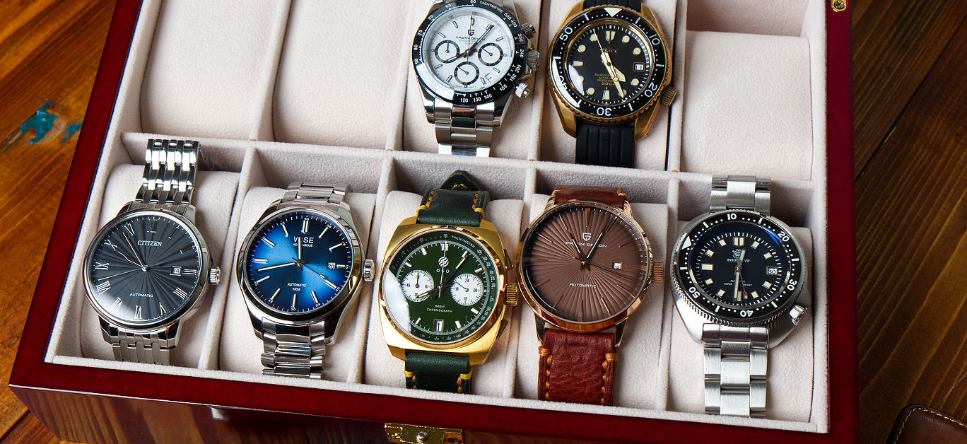Various Collection of Wrist Watches in the Watches Box on the Wood Table