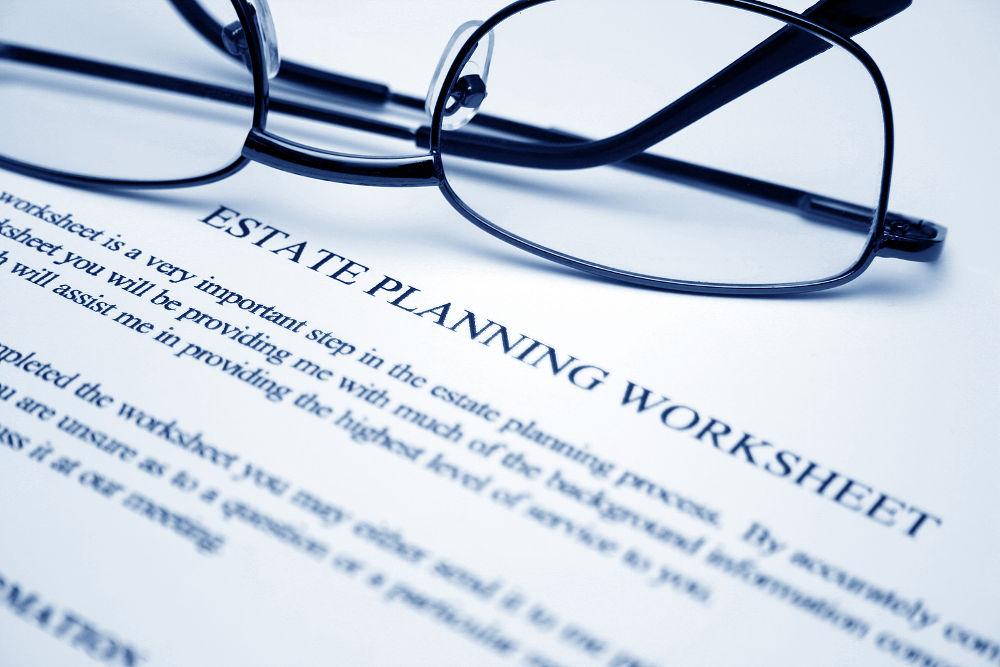 Close up of reading glasses on Estate planning worksheet