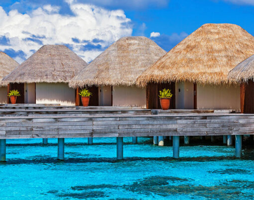 Luxury beach resort on Maldives, many cute bungalows standing on transparent water, Indian ocean, romantic place for honeymoon, summer vacation concept