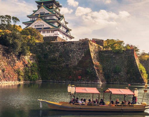 Touristic boat with tourists along the moat of Osaka Castle is one of the best activities you can experience around Osaka Castle area, Osaka, Japan.