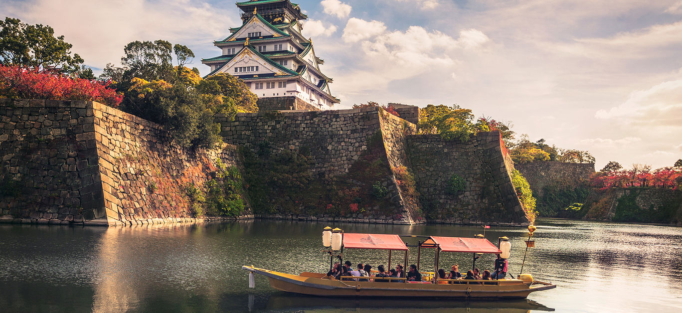 Touristic boat with tourists along the moat of Osaka Castle is one of the best activities you can experience around Osaka Castle area, Osaka, Japan.