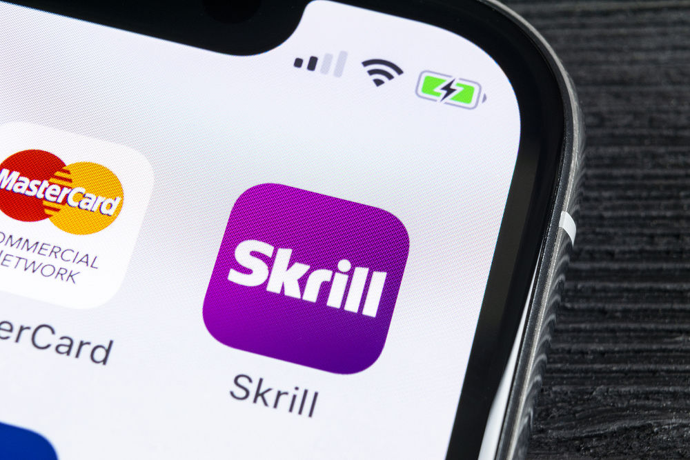 Skrill application icon on Apple iPhone X smartphone screen close-up