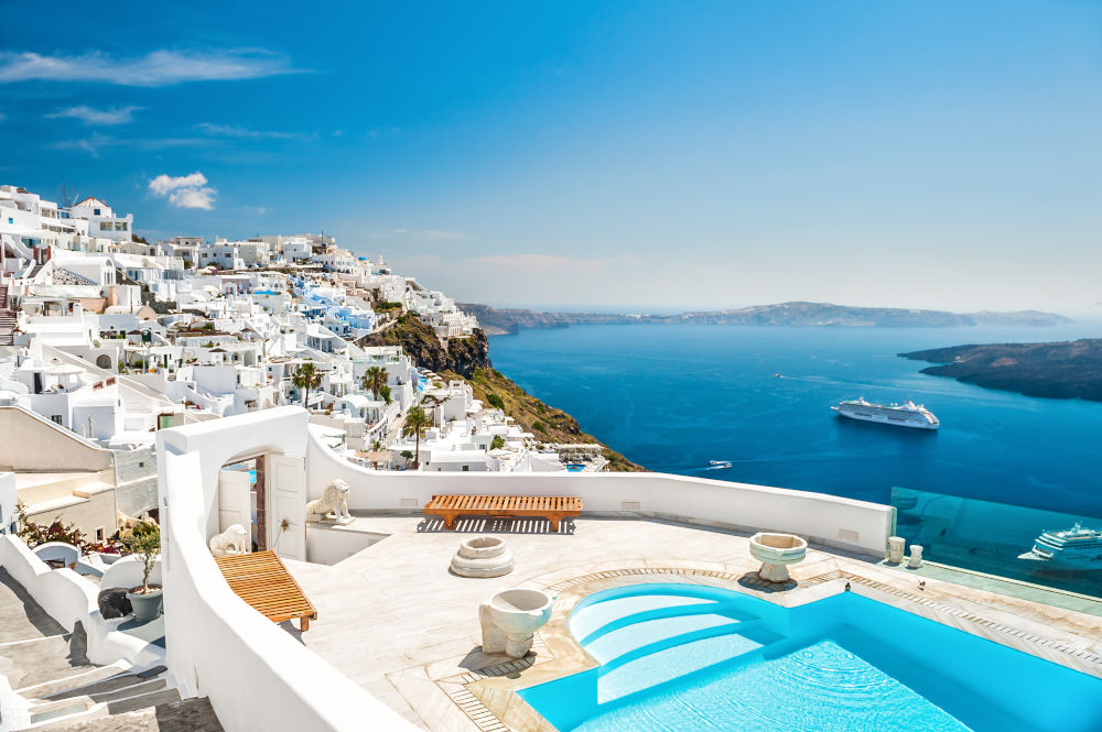 White architecture on Santorini island Greece. Swimming pool in luxury hotel. Beautiful view on the sea