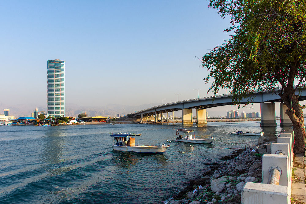 Ras Al Khaimah City in the United Arab Emirates in the late afternoon at the Corniche towards the Julphar Towers and bridge