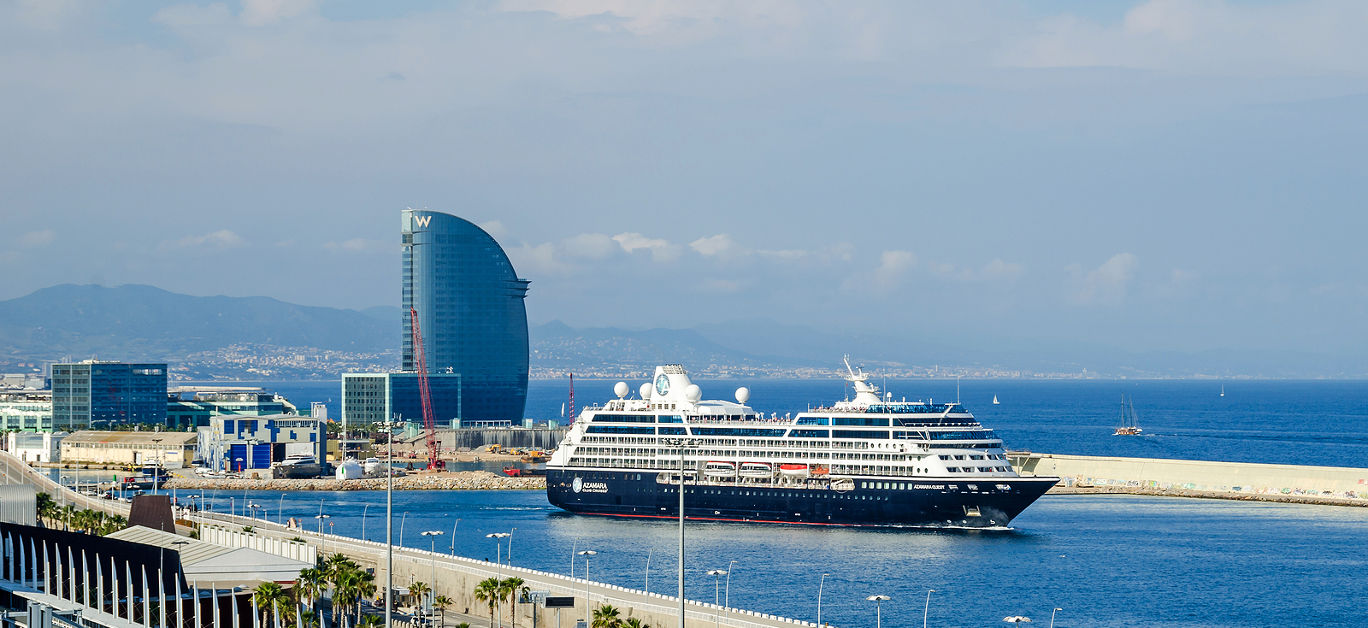 View of port Vell and its cruise terminal with cruise-liner Azamara and W Barcelona also known as the Hotel Vela (Sail Hotel).