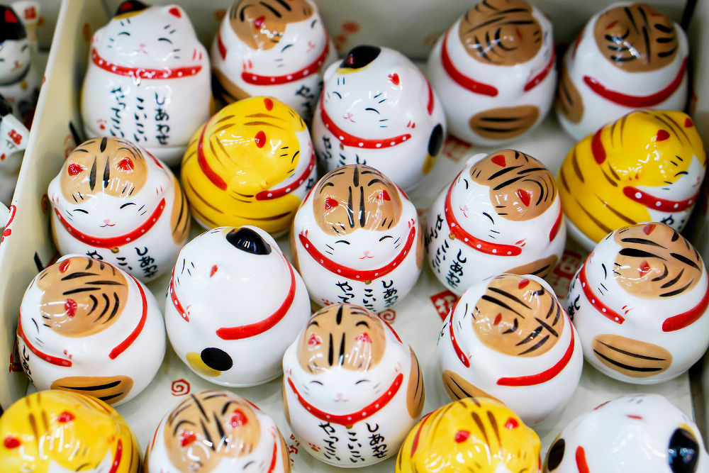 Top view and closeup Japanese souvenir (ceramic lucky cats) sell in second hand shop at Namba market.