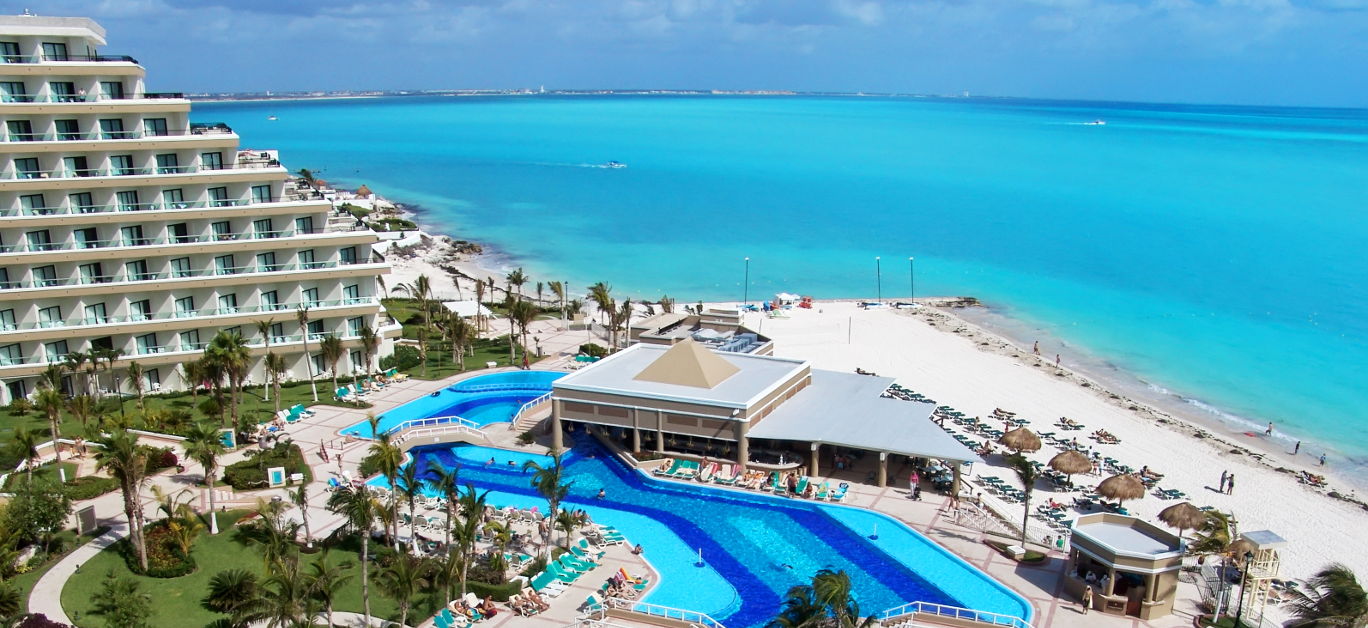 Luxurious hotel with a swimming pool at Cancun Mexico. Perfect tropical vacation. Caribbean Sea.