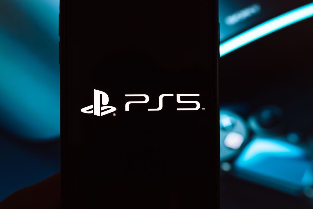 Smartphone with Sony Playstation 5 logo on screen. PS5 is the new 2020 game console. High quality photo.