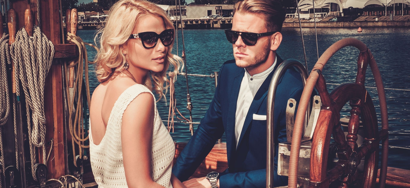 Stylish wealthy couple on a luxury yacht