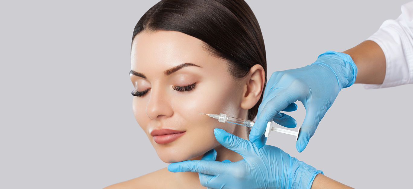 The doctor cosmetologist makes the Rejuvenating facial injections procedure for tightening and smoothing wrinkles on the face