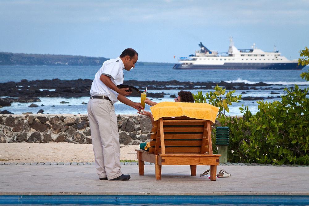 Unidentified tourist in a beach hotel enjoying the ocean view, Santa Cruz, Galapagos Islands