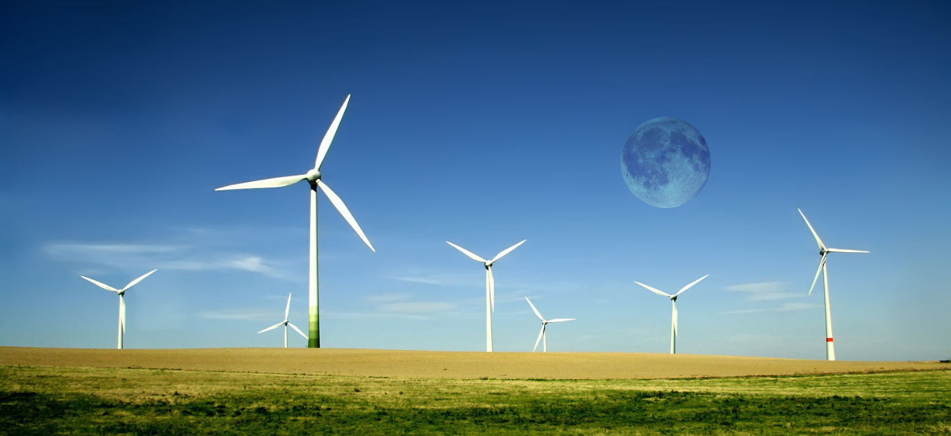 Wind turbines farm with full moon. Alternative energy source.