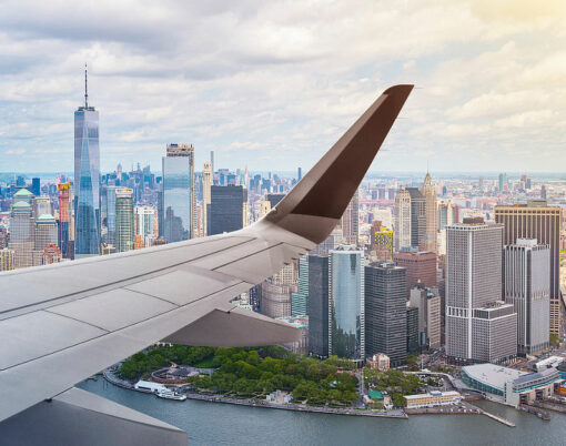 aerial view of New York City, Manhattan, from an airplane with wing in front, travel concept