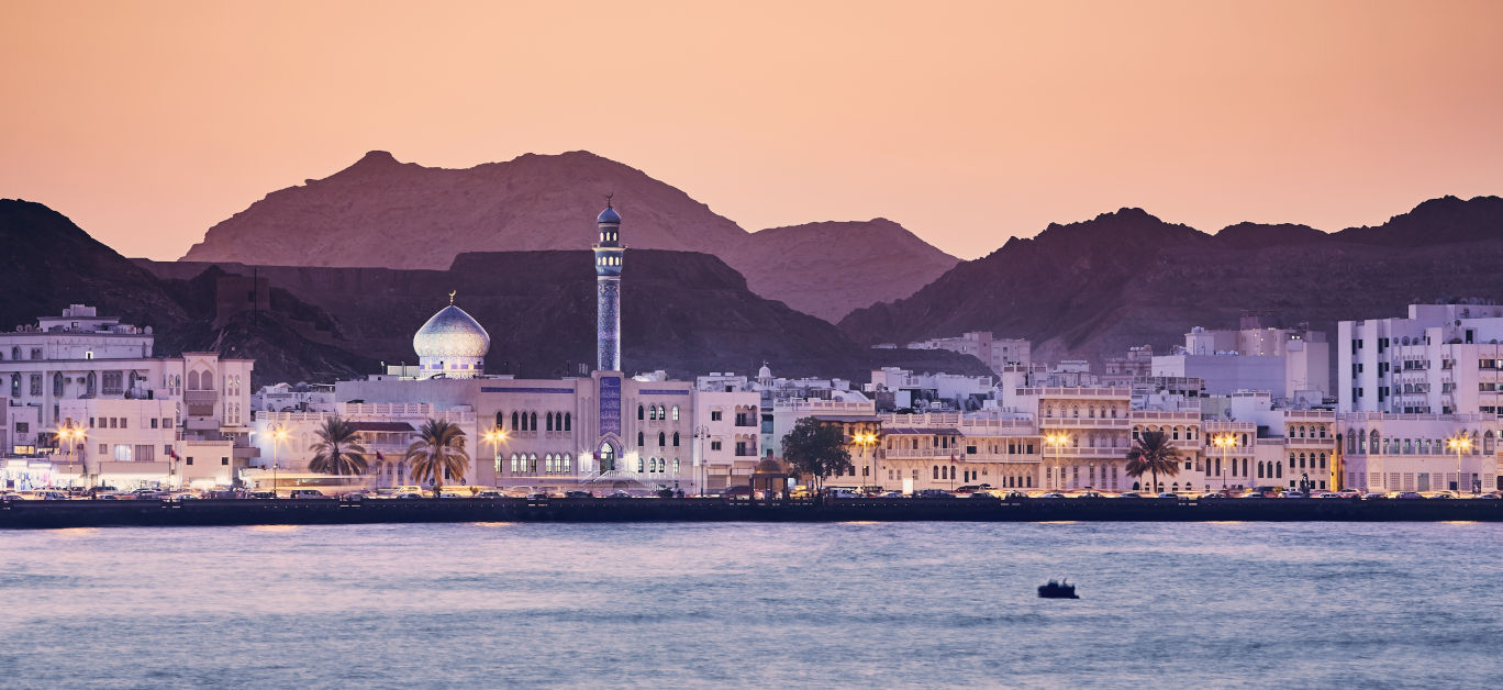 Cityscape view of Muscat city at golden sunset. The capital of Oman.