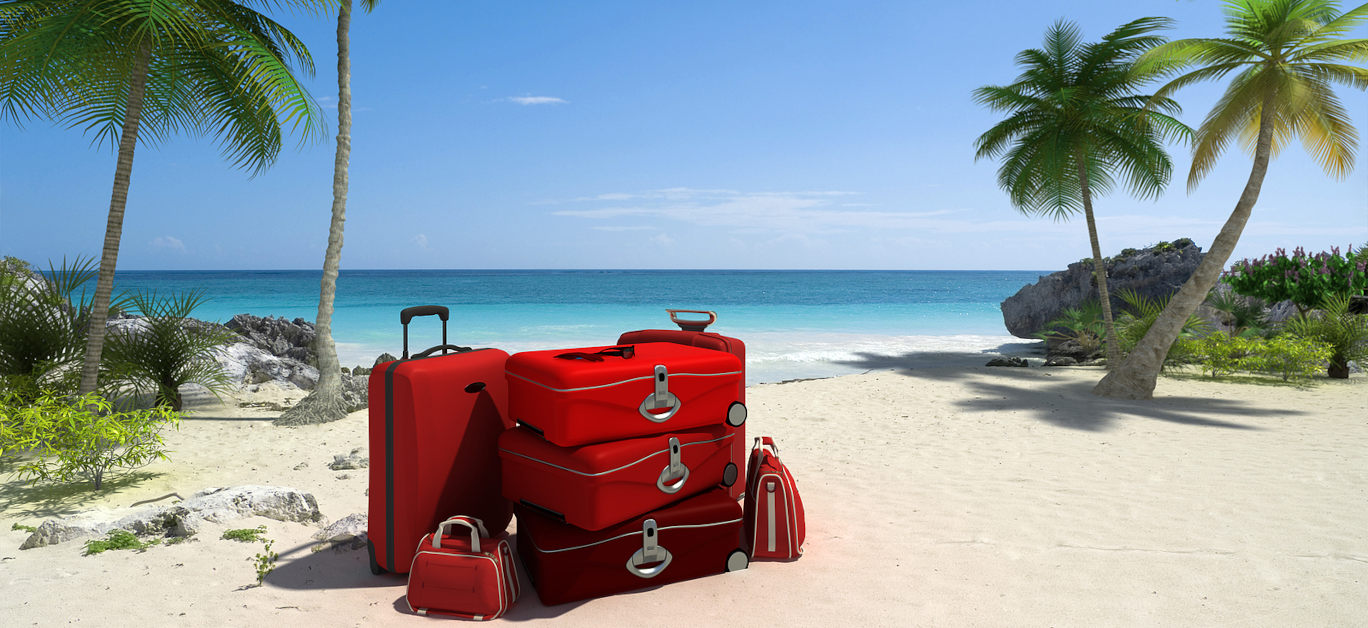 Pile of red luggage on a tropical beach