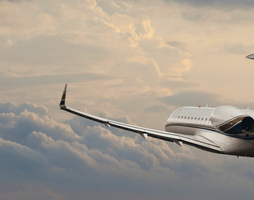Private jet in flight through cloudy skies