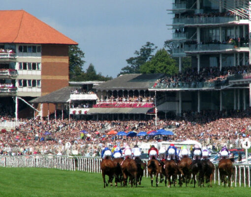 Horse racing at York race course showing riders nearing finishing post