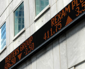 Financial market tickertape board outside city of London building