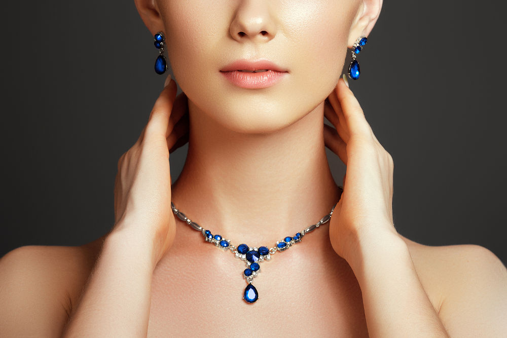 Elegant fashionable woman with jewelry. Beautiful woman with a sapphire necklace
