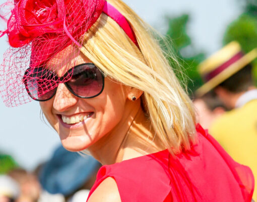 Lovely smiling woman with a pretty hat at the Prix de Diane The Prix de Diane is a French horse race which runs every year in June.