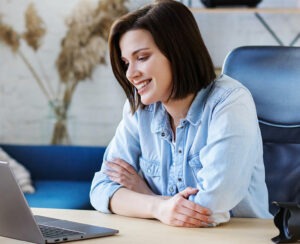 Working from home.Communication online with colleagues and freelancers and video conference. Portrait of smiling female freelancer using laptop for a online meeting in video call.