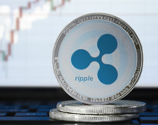 RIPPLE (XRP) cryptocurrency; physical concept ripple coin on the background of the chart