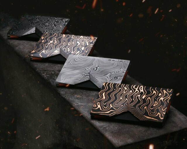 ‭Explore the Artistry of Strength: Bejeti’s Damascus Steel Collection‬. 

‭Surrender to the fusion of fortitude and finesse with Bejeti’s Damascus Steel, a material celebrated both for its ‬
‭robustness and breathtaking beauty. Renowned for its intricate, hand-forged patterns, each piece captivates, ‬
‭orchestrating a symphony of visual and tactile allure.‬ 

‭At Bejeti, our commitment to exquisite craftsmanship combines this esteemed steel with cutting-edge engineering. The outcome? A wallet that not only safeguards but elevates your daily essentials into a declaration of elegance and innovation.‬ 

‭Redefine the mundane and surpass the ordinary with Bejeti. Immerse yourself in a life where every detail contributes to the grand tapestry of your narrative, transforming everyday moments into strokes of genius on the canvas of your existence.‬